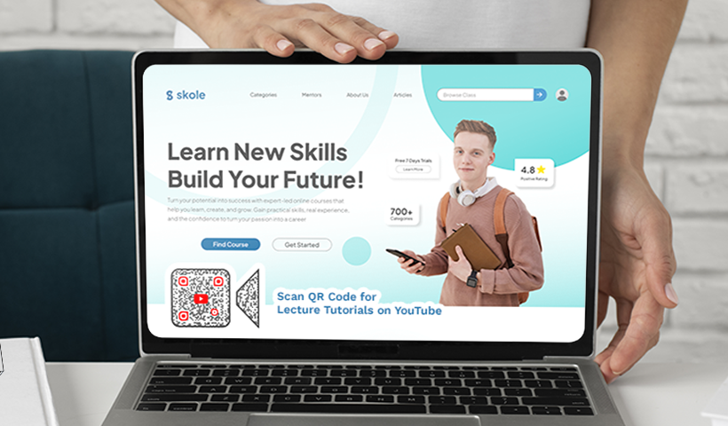 Laptop displaying an online learning website featuring a QR code for video tutorials.